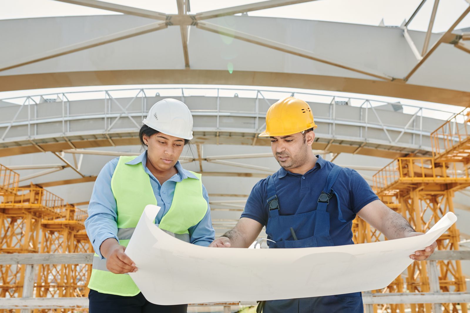 Two EHSS professionals reviewing site plans on a construction site